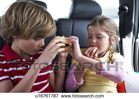 Kids eating a snack View Large Photo Image Stock Photo - Kids eating a snack. Fotosearch