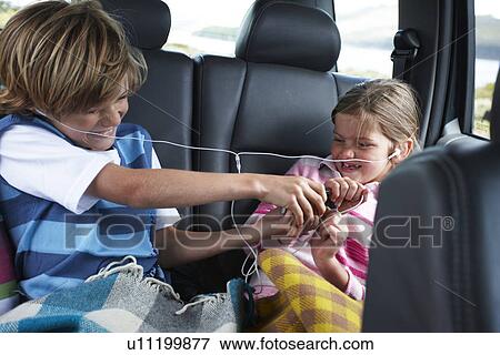 Kids fighting in the back of a car View Large Photo Image Stock Photo - Kids fighting in the back of a car. Fotosearch