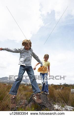 Kids in a field View Large Photo Image Picture - Kids in a field. Fotosearch