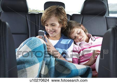 Kids in the back of a car View Large Photo Image Picture - Kids in the back of a car. Fotosearch
