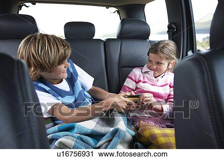 Stock Image - Kids not able to share mp3 player. Fotosearch