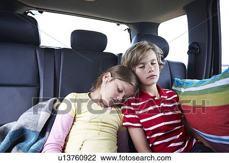Kids sleeping in the back of a car View Large Photo Image Stock Image - Kids sleeping in the back of a car. Fotosearch