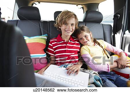 Kids with a computer in a car View Large Photo Image Stock Image - Kids with a computer in a car. Fotosearch