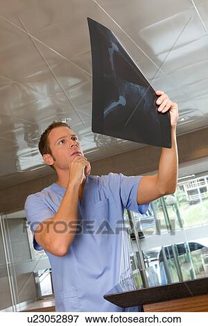 Stock Photo - Looking at an x-ray. Fotosearch