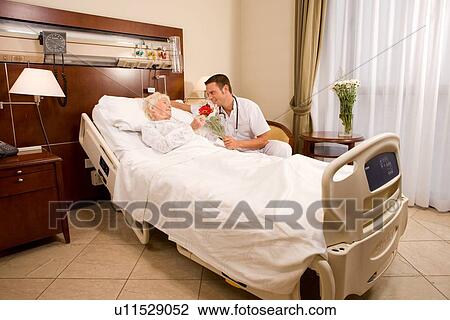 Stock Image - Male nurse and a patient. Fotosearch