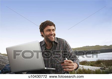 Stock Image - Man buying online. Fotosearch