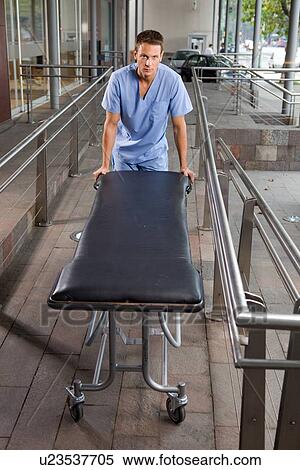 Man pushing a stretcher View Large Photo Image Stock Photography - Man pushing a stretcher. Fotosearch