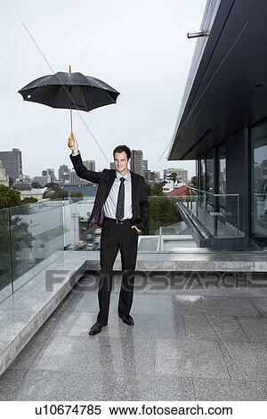 Stock Photography - Man standing in the rain. Fotosearch