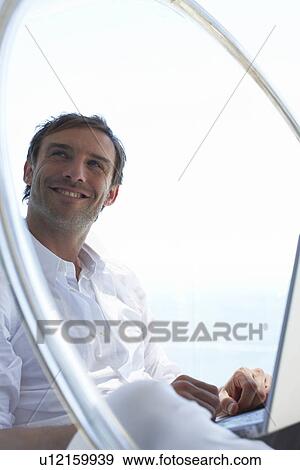 Man with laptop View Large Photo Image Stock Photo - Man with laptop. Fotosearch