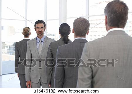 Stock Image - Manager with his team. Fotosearch