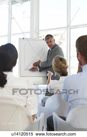 Stock Photography - Mature businessman presenting. Fotosearch
