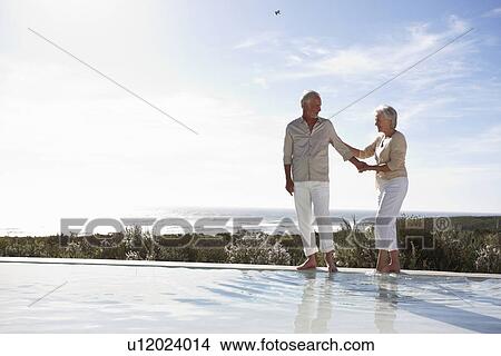 Mature couple at a pool View Large Photo Image Picture - Mature couple at a pool. Fotosearch