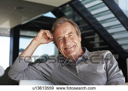Stock Photo - Mature man in his house. Fotosearch