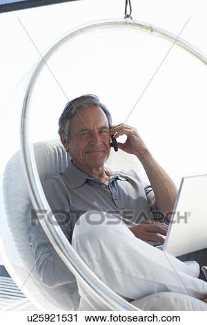 Stock Image - Mature man making a call. Fotosearch