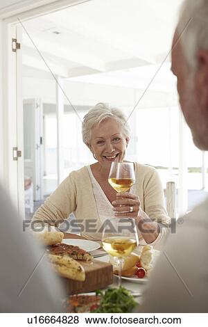 Stock Photo - Mature woman with a glass of wine. Fotosearch