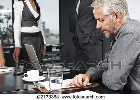 Middle aged businessman at work View Large Photo Image Stock Photo - Middle aged businessman at work. Fotosearch
