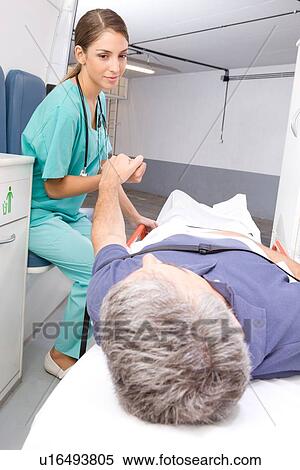 Stock Photography - Nurse caring after a patient. Fotosearch