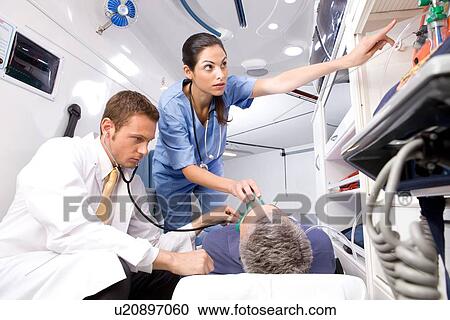 Stock Image - Nurse putting an oxygen mask. Fotosearch