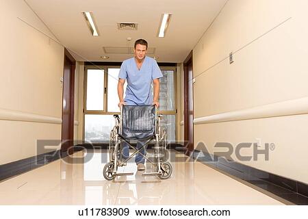 Stock Photo - Nurse with a wheelchair. Fotosearch