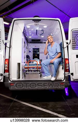 Paramedic making a call View Large Photo Image Stock Photo - Paramedic making a call. Fotosearch