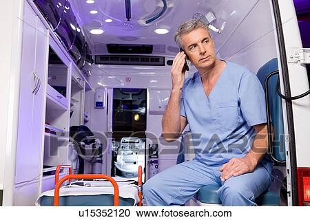 Stock Image - Paramedic on a phone. Fotosearch
