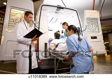 Stock Photo - Paramedics with a patient. Fotosearch