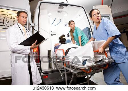 Stock Image - Paramedics with a stretcher. Fotosearch