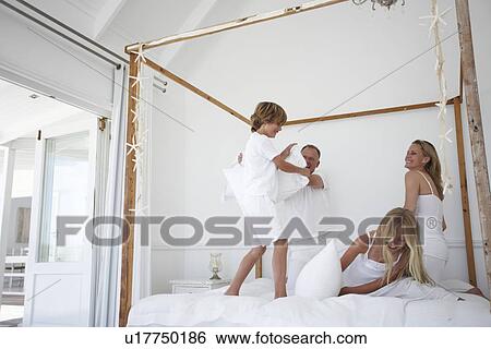 Stock Photograph - Parents playing with their children. Fotosearch