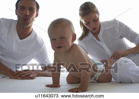 Stock Image - Parents with their baby. Fotosearch