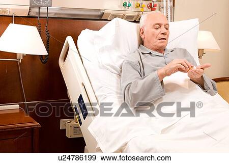Patient taking pills View Large Photo Image Stock Photo - Patient taking pills. Fotosearch