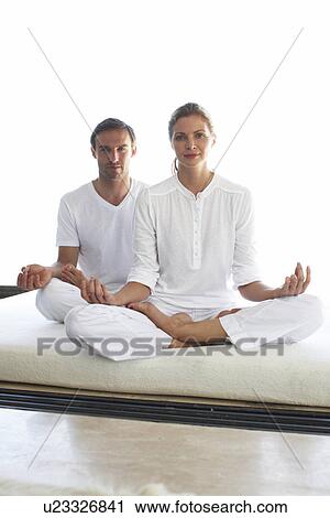Stock Image - People doing yoga. Fotosearch