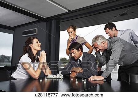 Stock Photo - People playing chess. Fotosearch