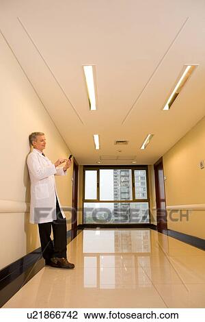 Physician with a mobile phone View Large Photo Image Stock Image - Physician with a mobile phone. Fotosearch