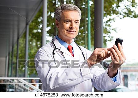 Stock Image - Physician with a telephone. Fotosearch
