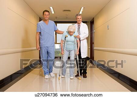 Physicians helping to walk View Large Photo Image Stock Photograph - Physicians helping to walk. Fotosearch