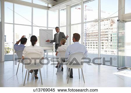 Stock Photography - Presenting company results. Fotosearch