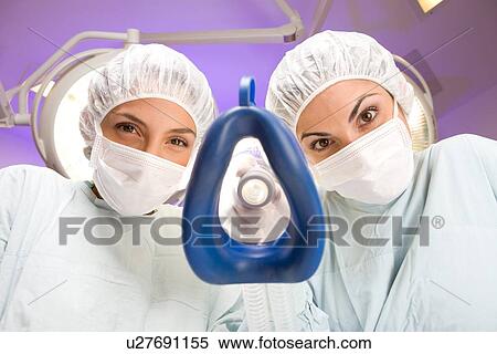 Putting an oxygen mask on View Large Photo Image Stock Photography - Putting an oxygen mask on. Fotosearch