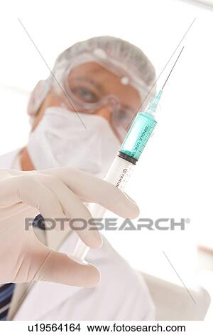 Picture - Scientist with a syringe. Fotosearch