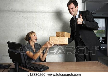 Stock Image - Secretary accepting a courier. Fotosearch
