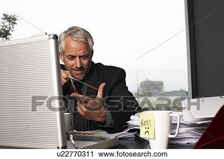 Stock Image - Senior businessman at work. Fotosearch