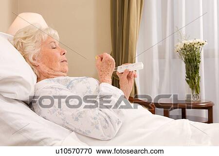Senior woman taking pills View Large Photo Image Stock Image - Senior woman taking pills. Fotosearch