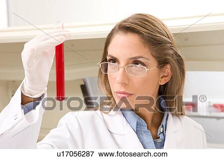 Stock Photo - Studying a sample in a lab. Fotosearch