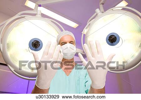 Stock Photo - Surgeon preparing for operation. Fotosearch
