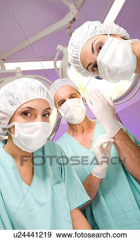 Stock Photo - Surgeon putting gloves on. Fotosearch