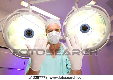 Surgeon with surgical gloves View Large Photo Image Stock Image - Surgeon with surgical gloves. Fotosearch