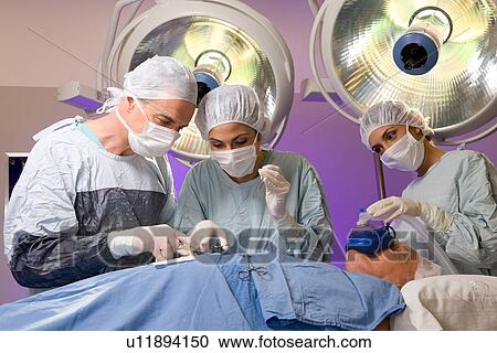 Surgeons at work View Large Photo Image Stock Image - Surgeons at work. Fotosearch