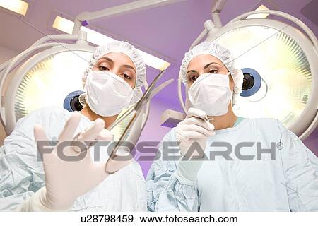 Surgeons at work View Large Photo Image Stock Photo - Surgeons at work. Fotosearch