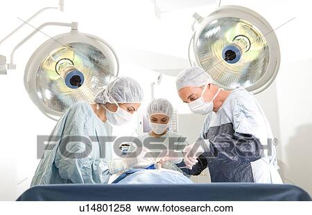Stock Photo - Surgeons operating. Fotosearch