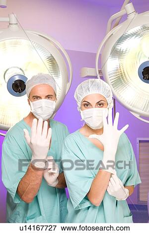 Stock Photo - Surgeons preparing for operation. Fotosearch