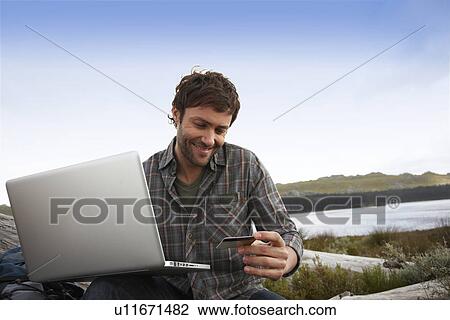 Stock Image - Tourist with a computer. Fotosearch